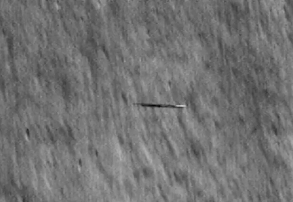 The “surfboard” flying in front of the moon in NASA footage is actually an artificial object